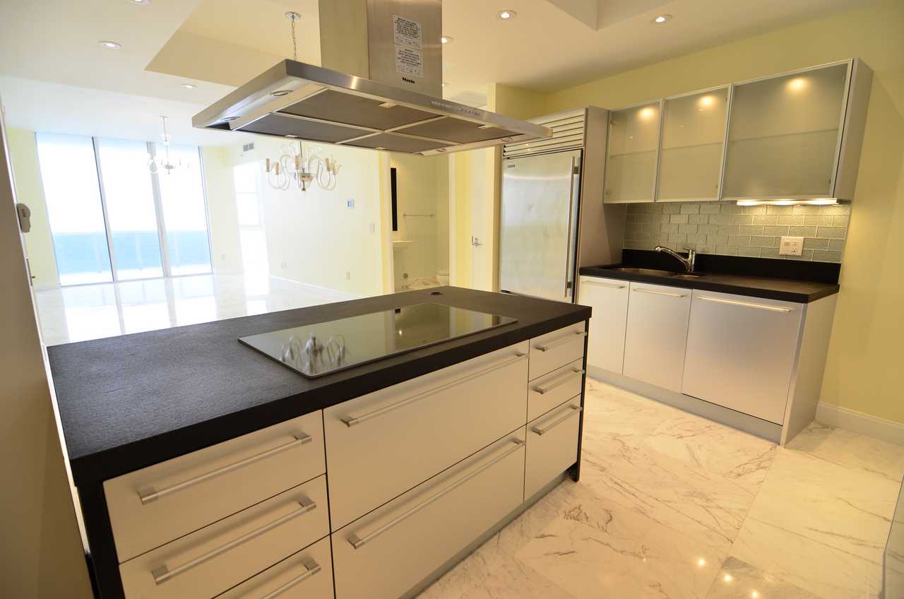 Kitchen remodeling Miami modern condo kitchen with island and ocean view